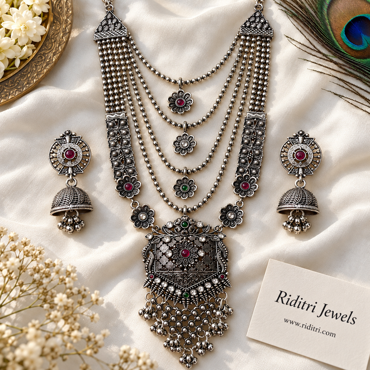 Silver-toned oxidised jaali pendant with red, green and clear stones and ghungroo beads