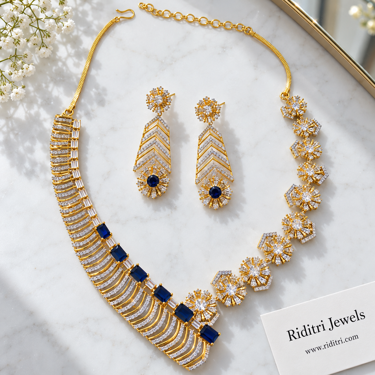 Sapphire blue AD earrings with starburst stud and chevron drop for cocktail party