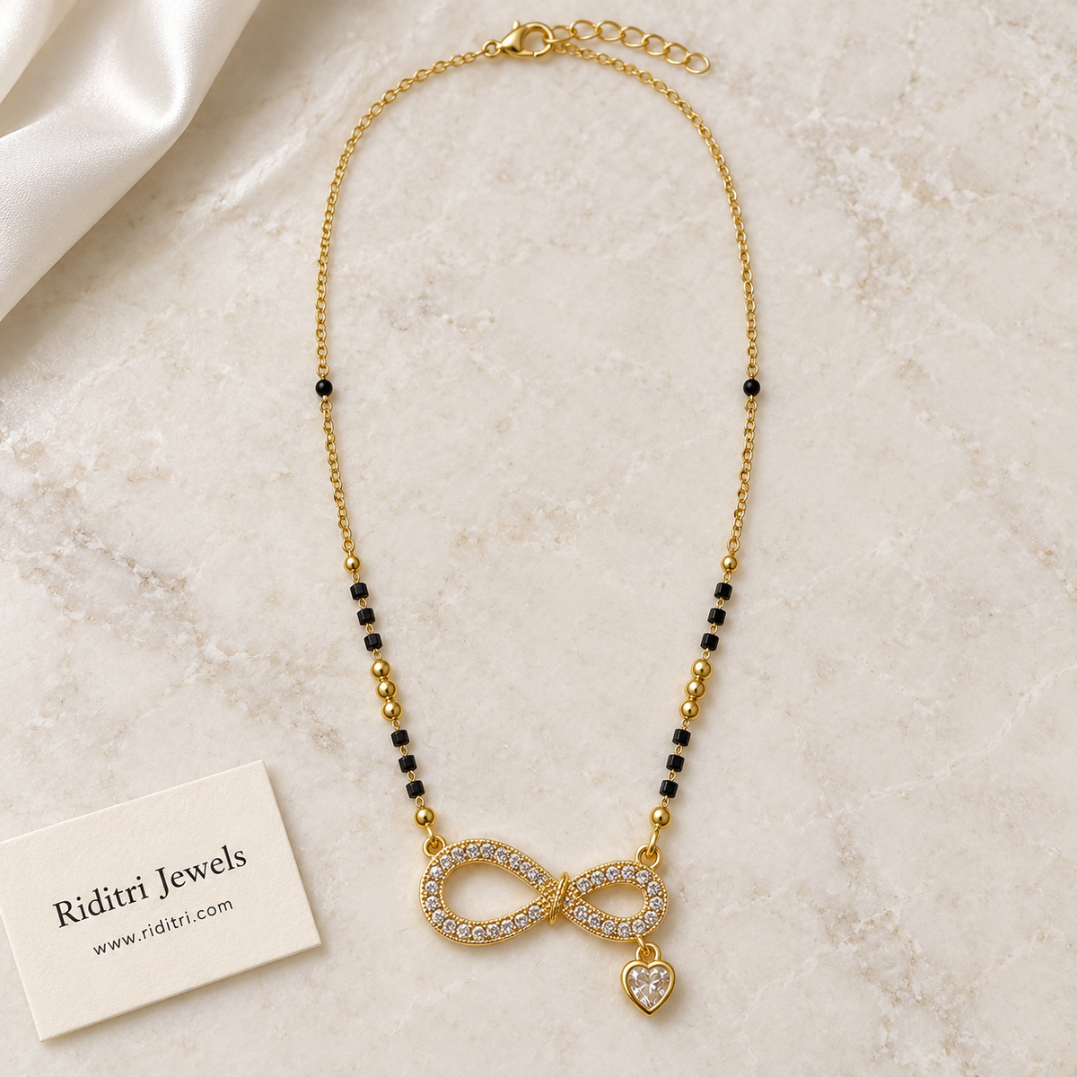 Daily wear black bead mangalsutra chain with gold beads and infinity heart pendant