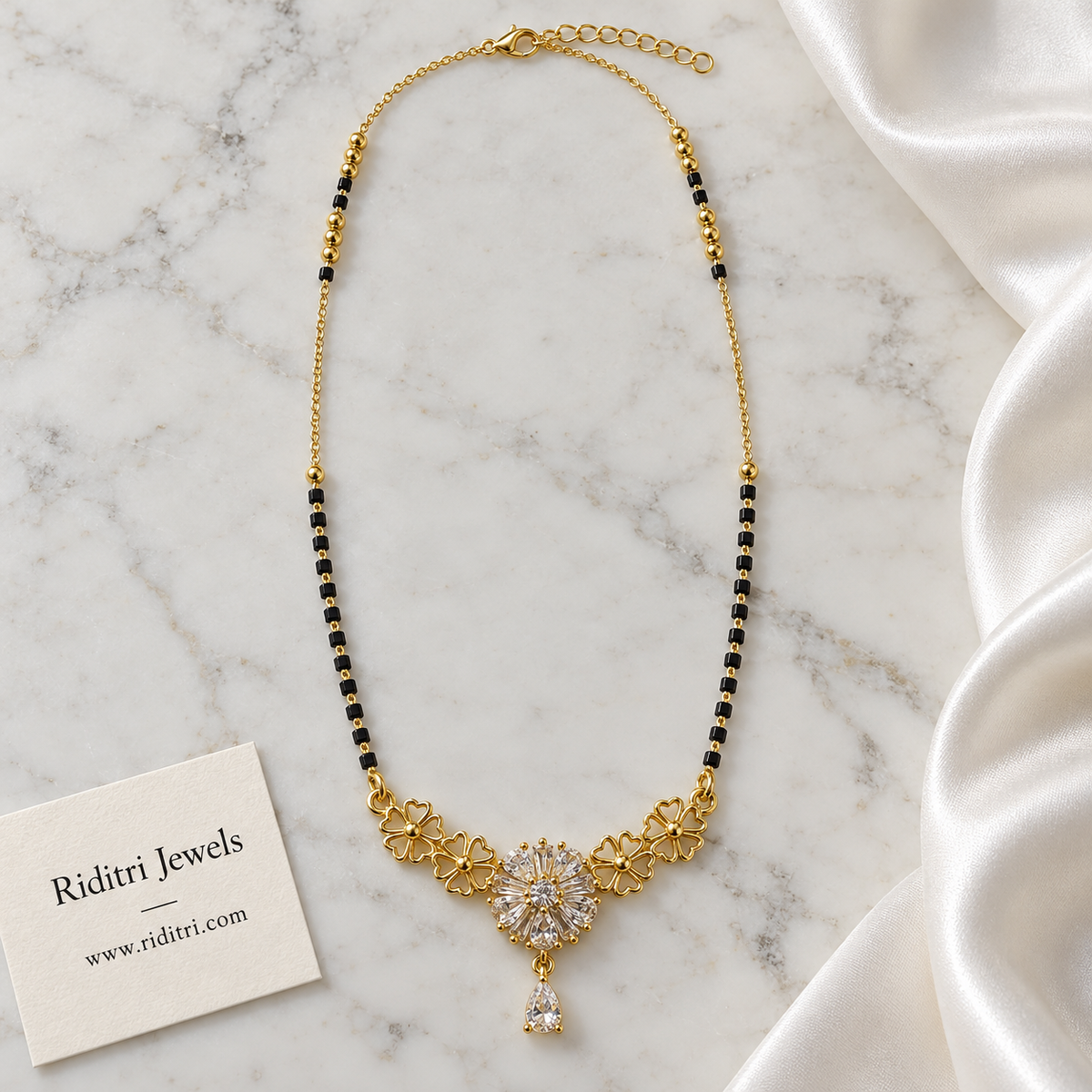 Long black bead mangalsutra chain with gold beads and floral teardrop pendant