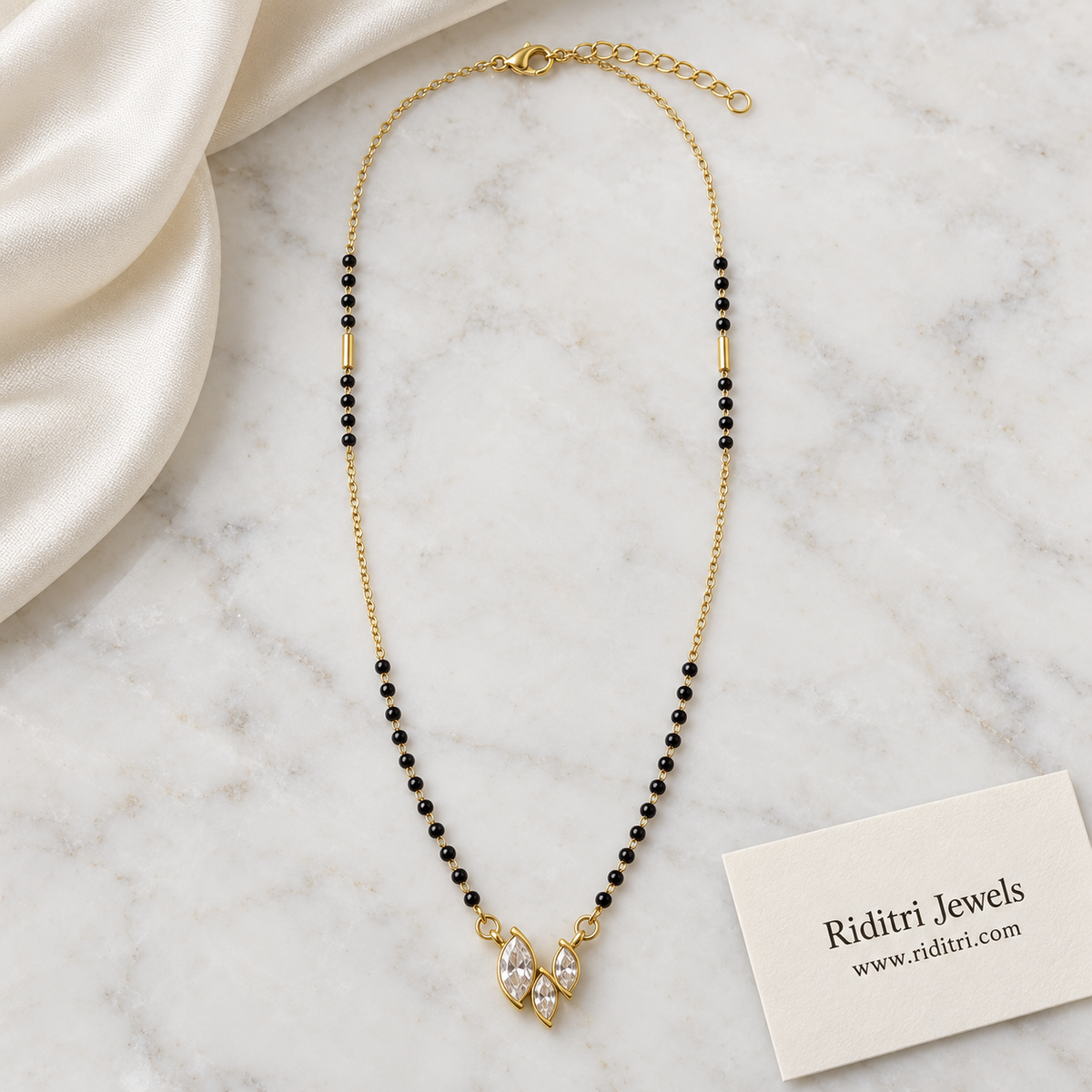 Minimal black bead mangalsutra chain with gold tube beads and marquise pendant