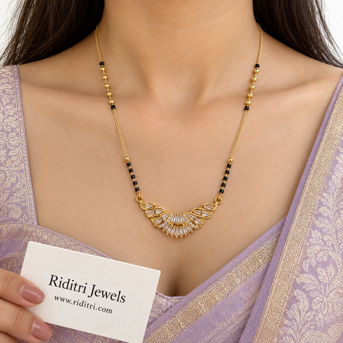 Gold-toned crescent mangalsutra pendant with fan of baguette AD stones and swirls