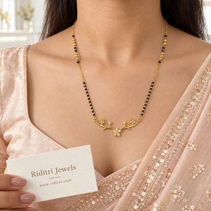 Gold-toned curved branch mangalsutra pendant with stone flower and stone buds