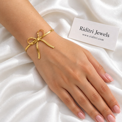 Anti Tarnish Gold Bow Bracelet worn on the wrist – gold-toned bow on a sleek flat chain, view 2