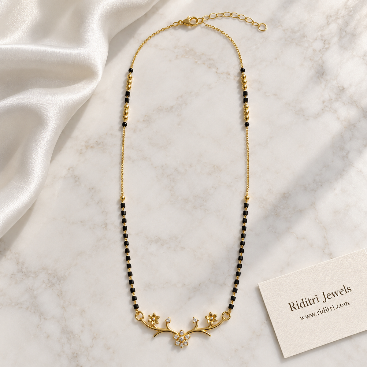 Square black bead mangalsutra chain with gold ball beads and floral branch pendant