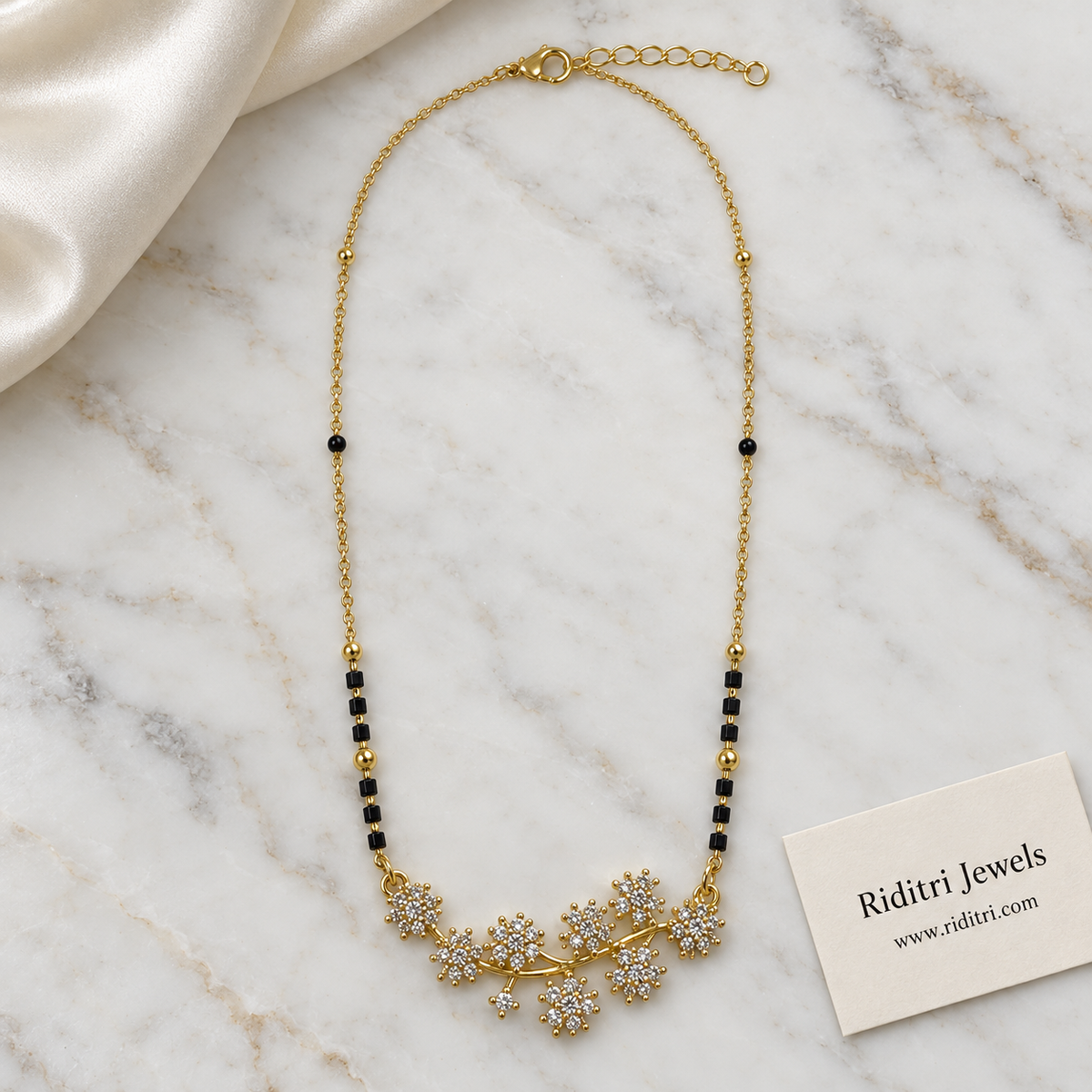 Black bead mangalsutra chain with gold beads and diamond-look flower vine pendant