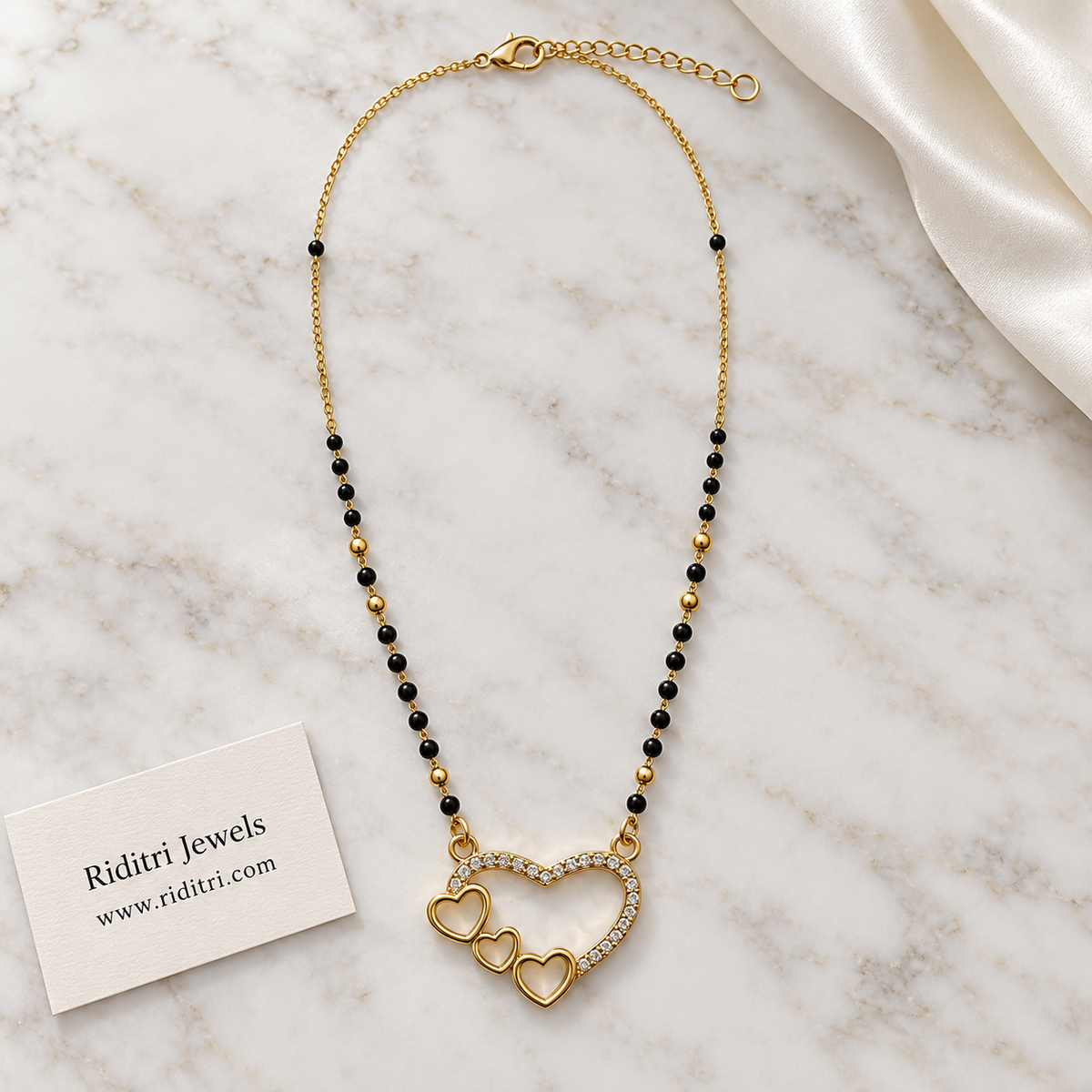Gold-toned open heart mangalsutra pendant lined with sparkling stones