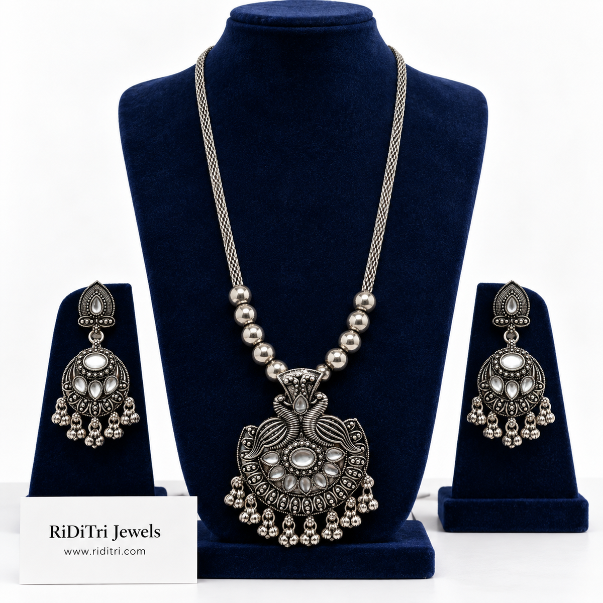 Mayur oxidised long necklace set with twin peacock pendant, clear kundan-style stones, ghungroo fringe and matching earrings by Riditri