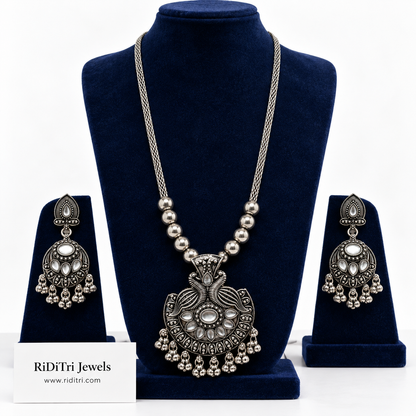 Mayur oxidised long necklace set with twin peacock pendant, clear kundan-style stones, ghungroo fringe and matching earrings by Riditri