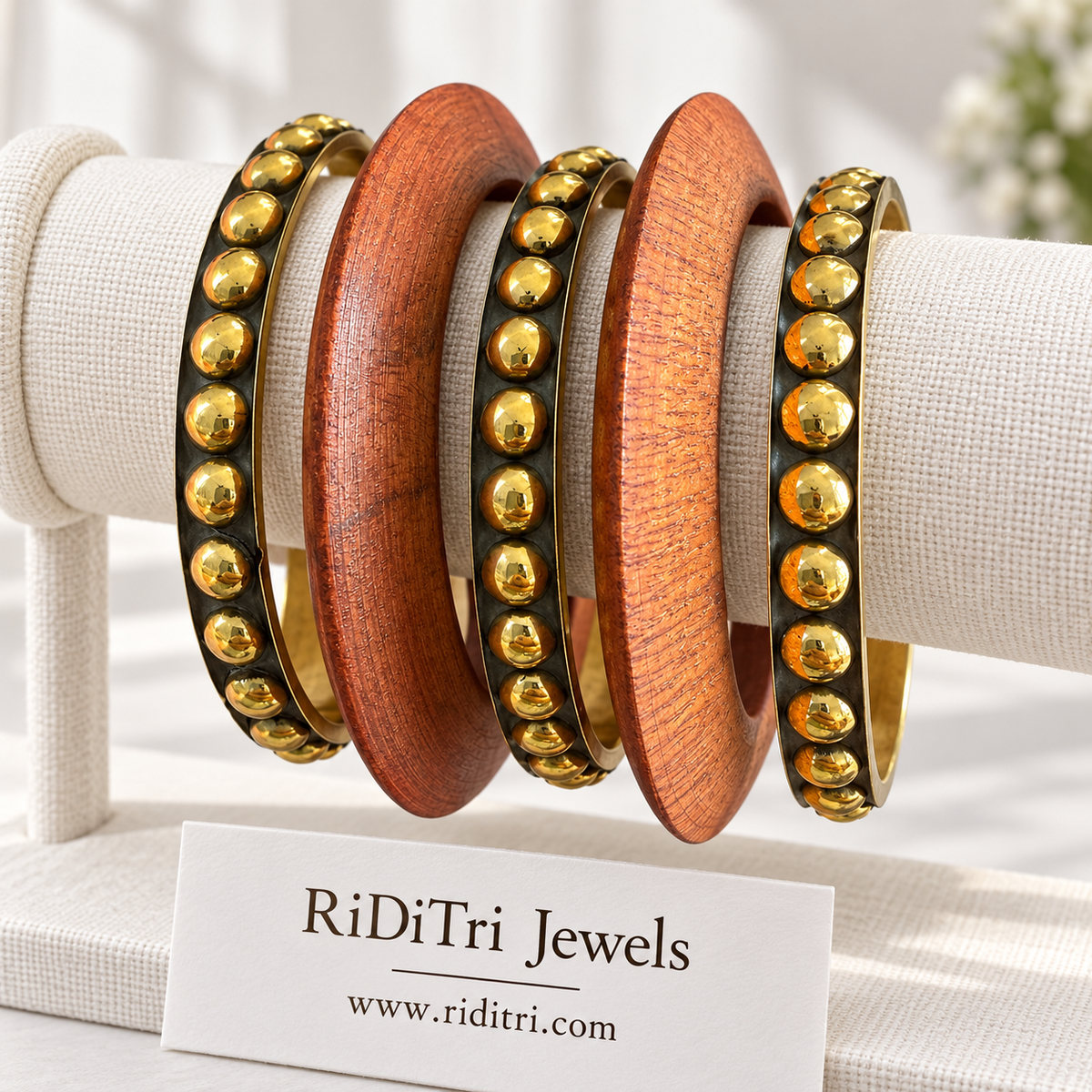 Vanam bangle set of 5 with two broad wooden bangles and three gold-toned bangles lined with round studs by Riditri