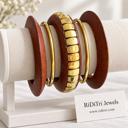 Vanashree statement bangle set of 5 with a wooden bangle set with large gold-toned blocks, two broad wooden bangles and two slim gold-toned bangles by Riditri
