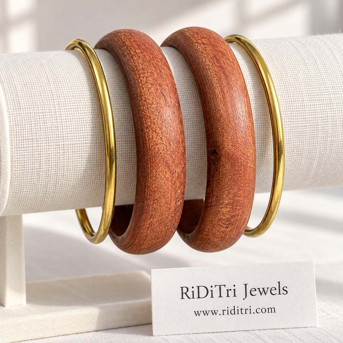 Vanmala bangle set of 4 with two smooth chunky wooden bangles and two slim gold-toned bangles by Riditri