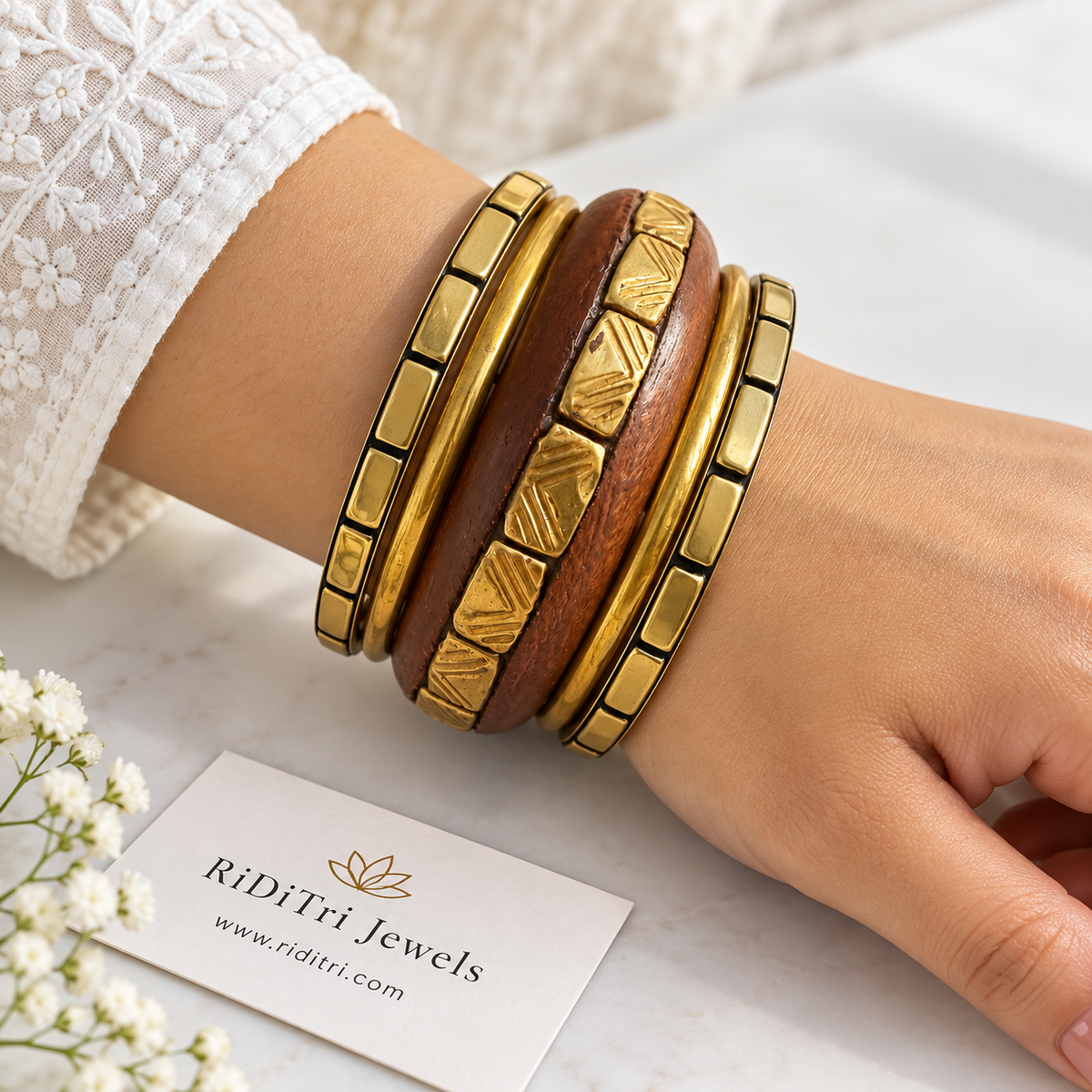 Kaanan bangle set of 5 with a wooden bangle set with engraved gold-toned blocks, two segmented and two slim gold-toned bangles by Riditri