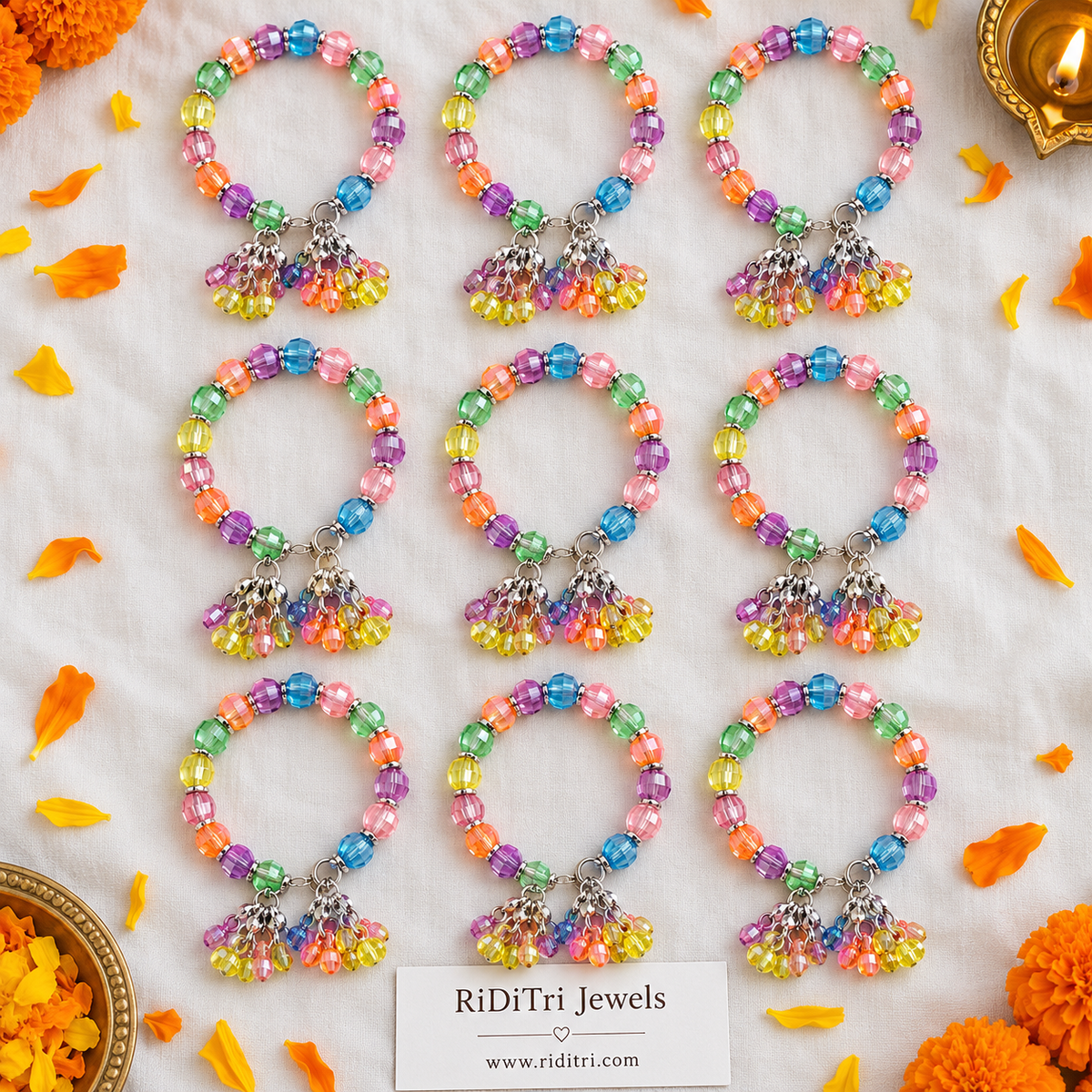 Kanya Pujan gift bracelet with pastel shimmer faceted beads, silver-toned spacers and hanging bead latkans for Kanjak by Riditri