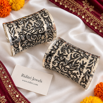 Phoolwari adjustable broad cuff bracelets pair with embossed floral and swirl pattern in two-tone oxidised finish by Riditri