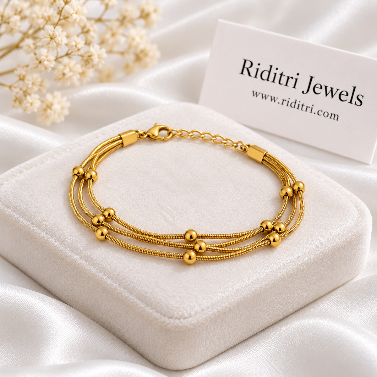 Anti tarnish stainless steel triple layer bracelet with three gold-toned snake chains and tiny gold beads by Riditri