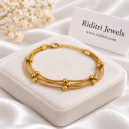 Anti tarnish stainless steel triple layer bracelet with three gold-toned snake chains and tiny gold beads by Riditri