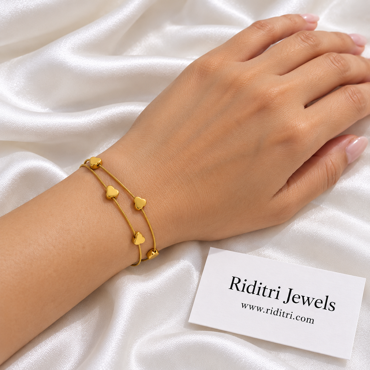 Anti Tarnish Double Heart Bracelet worn on the wrist – two layered chains with polished gold-toned hearts, view 2