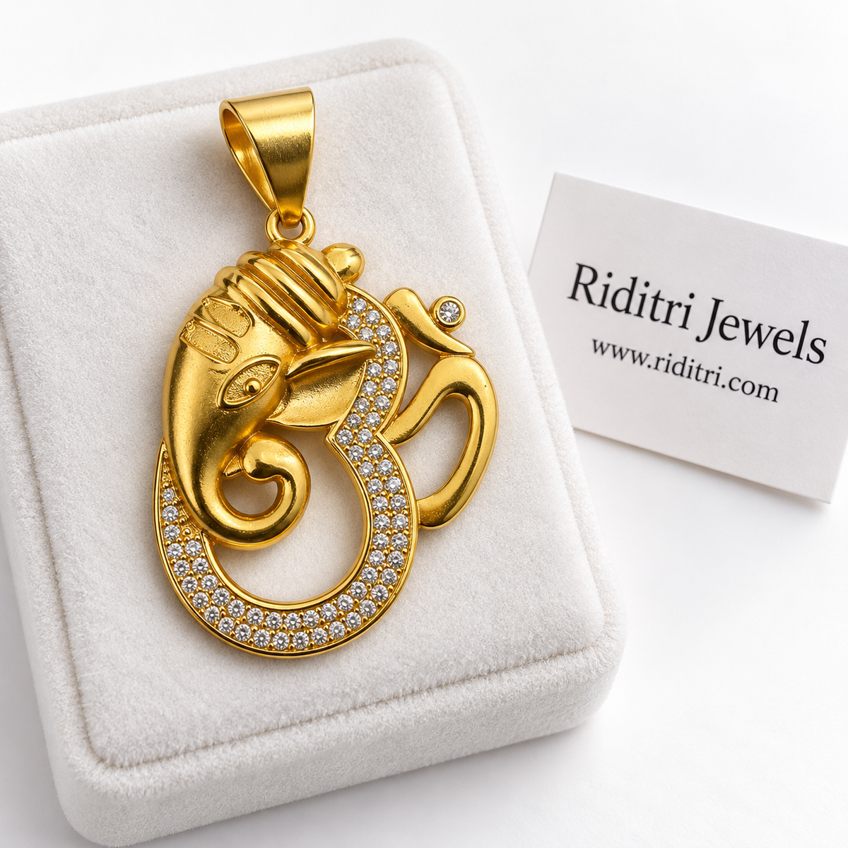Om Ganesha gold pendant with Lord Ganesha face blended into the Om symbol, lined with sparkling AD stones by Riditri