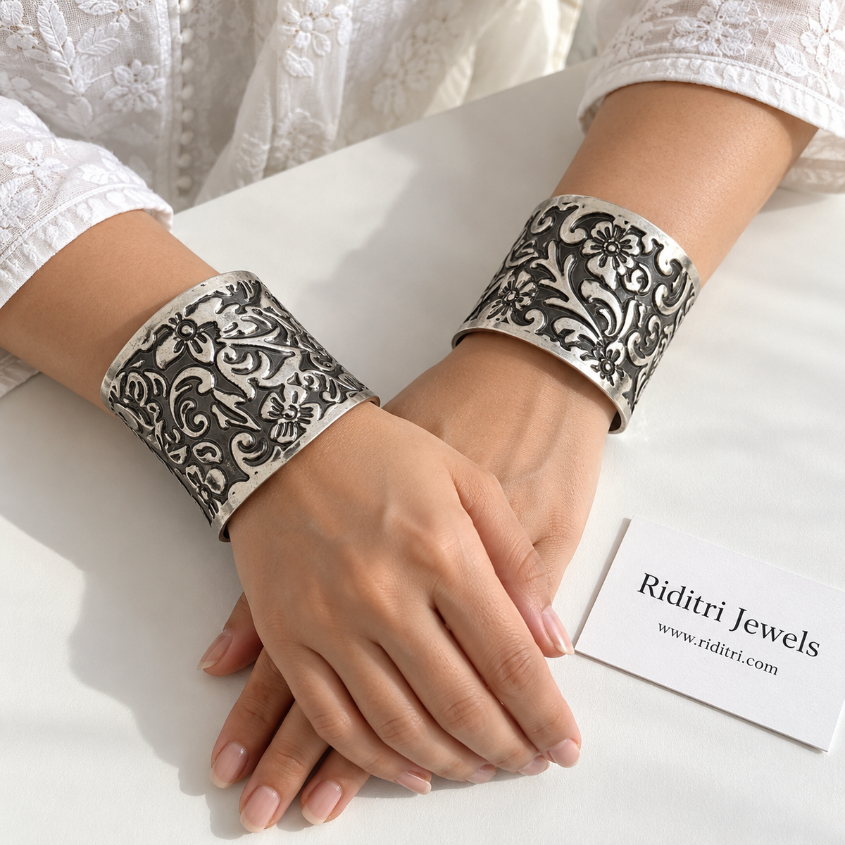 Phool jaal adjustable short cuff bracelets pair with all-over flower and swirl work in black-and-silver oxidised finish by Riditri