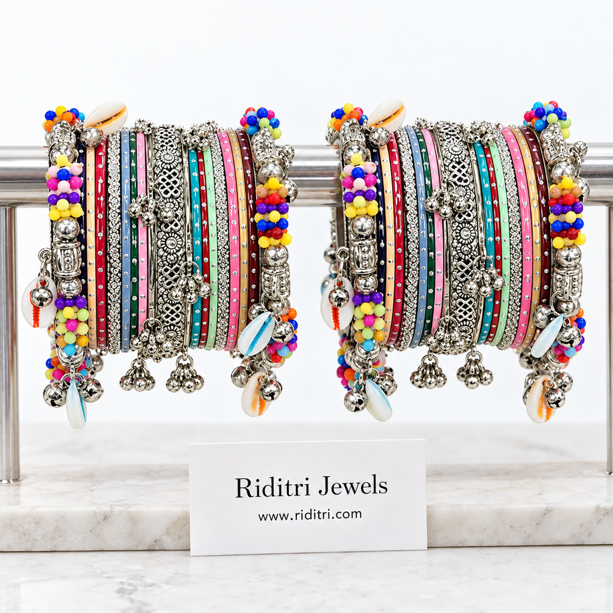 Kodi garba bangle set for both hands with colourful beaded kadas, kodi cowrie shells, ghungroos, multicolour and silver-toned bangles by Riditri
