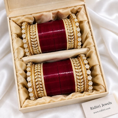 Maroon bridal chooda for both hands with glossy maroon bangles and sparkling AD stone leaf kadas by Riditri