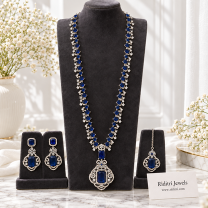 Sapphire blue stone pendant with clear AD-style stones on silver-toned long necklace
