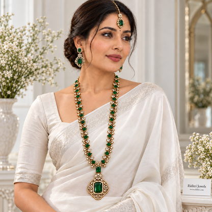 Gold-toned long necklace set with emerald green and clear stones by Riditri Jewels