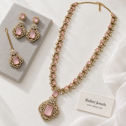 Blush pink stone pendant with clear AD-style stones on antique gold-toned long necklace