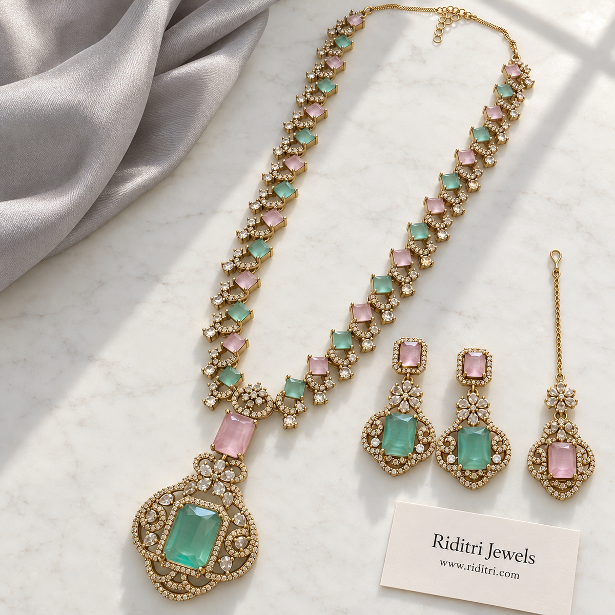 Mint green stone pendant with baby pink and clear AD-style stones on antique gold-toned necklace