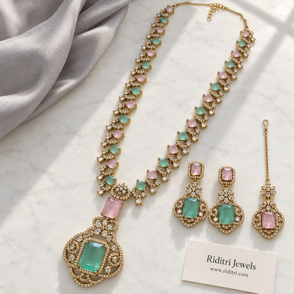 Mint green stone pendant with baby pink and clear AD-style stones on antique gold-toned necklace