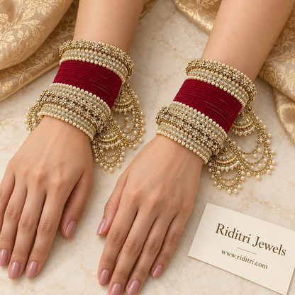 Maroon velvet bridal bangle set with reverse AD stone kadas, pearl borders and jhumka latkans