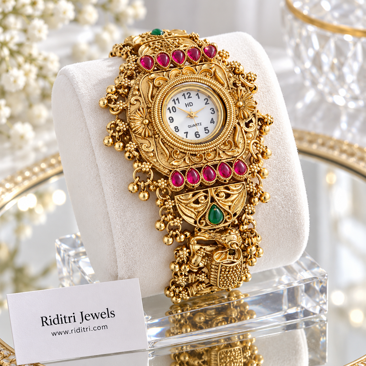 Gold plated jewellery watch with white dial, carved elephants and ghungroo clusters
