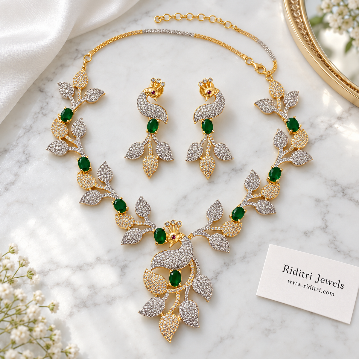Silver and gold two-tone peacock leaf necklace with emerald green stones for cocktail party