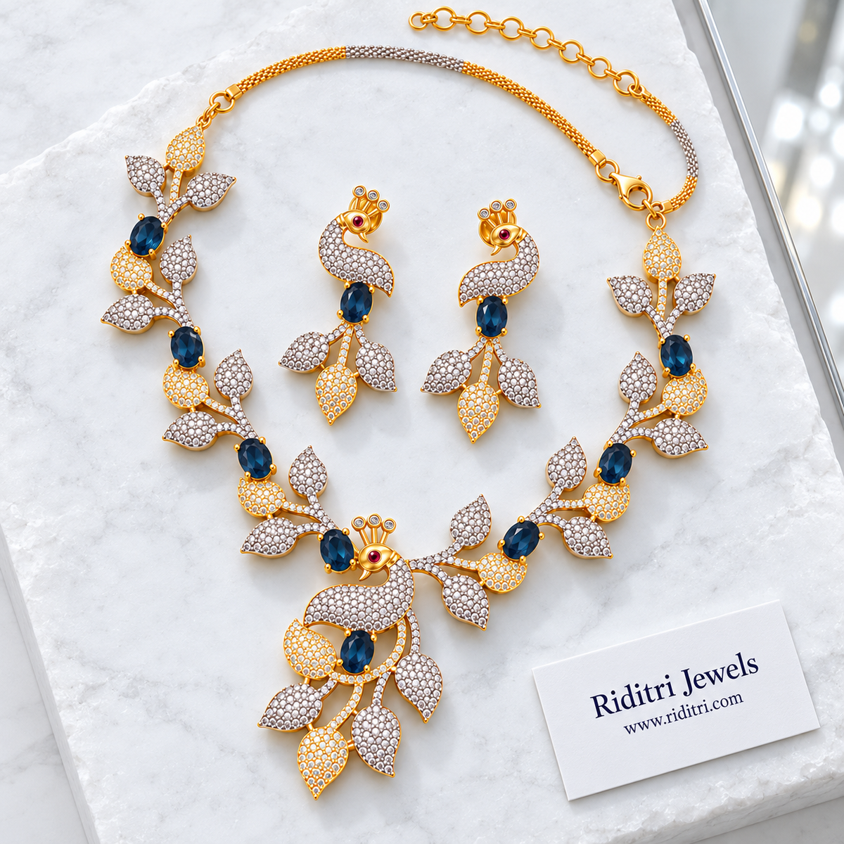 Silver and gold two-tone peacock leaf necklace with blue stones for cocktail party