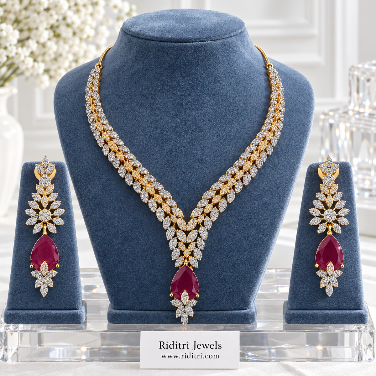 Inaaya two-tone AD leaf necklace set with ruby red teardrop stone and matching earrings