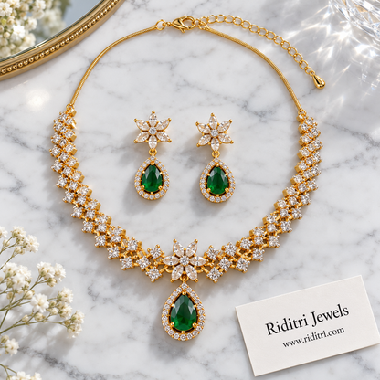 Zig-zag AD stone necklace with star flower centre and emerald green teardrop
