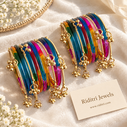Colourful transparent jelly glass bangles stacked with ghungroo bangles