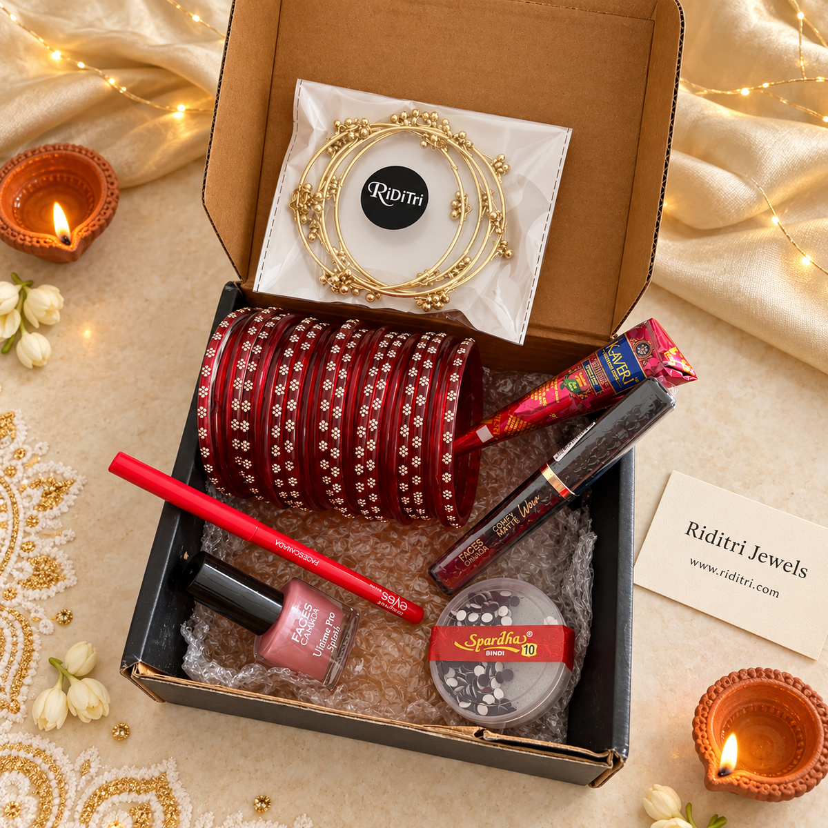 Bangle and beauty gift hamper with red glass bangles, gold ghungroo bangles, kajal, nail paint, bindi, lip colour and mehendi