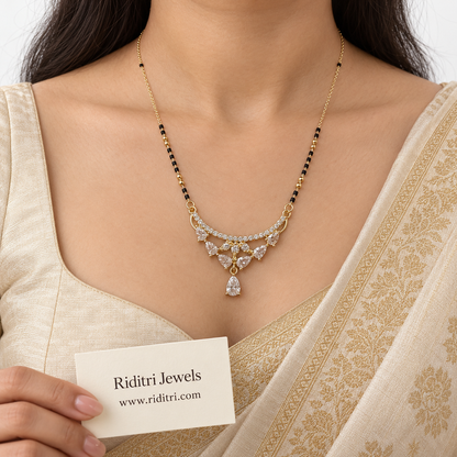 Close view of gold-toned mangalsutra pendant with pear-cut stones and teardrop drop