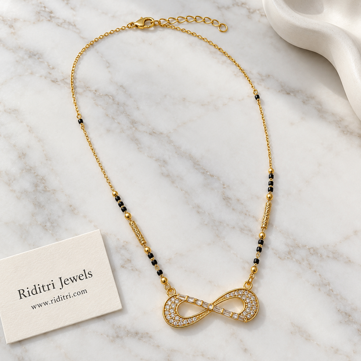 Daily wear black bead mangalsutra chain with textured gold beads and infinity pendant