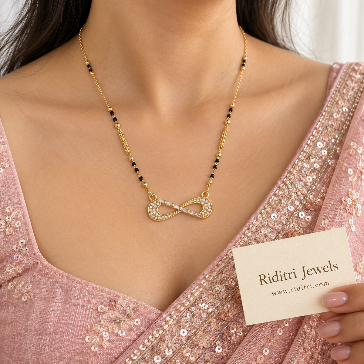 Gold-toned infinity mangalsutra pendant with pave and baguette stones