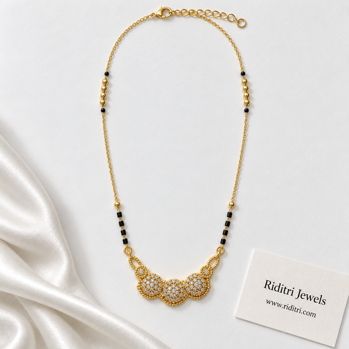 Gold-toned triple cluster mangalsutra pendant with twisted rope border