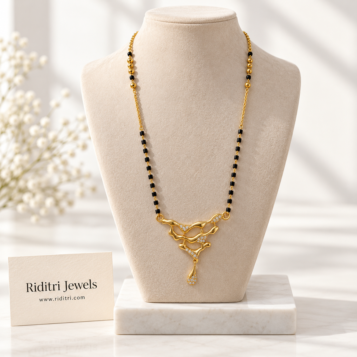 Designer gold-toned mangalsutra pendant with flowing waves, drip drop and AD stones