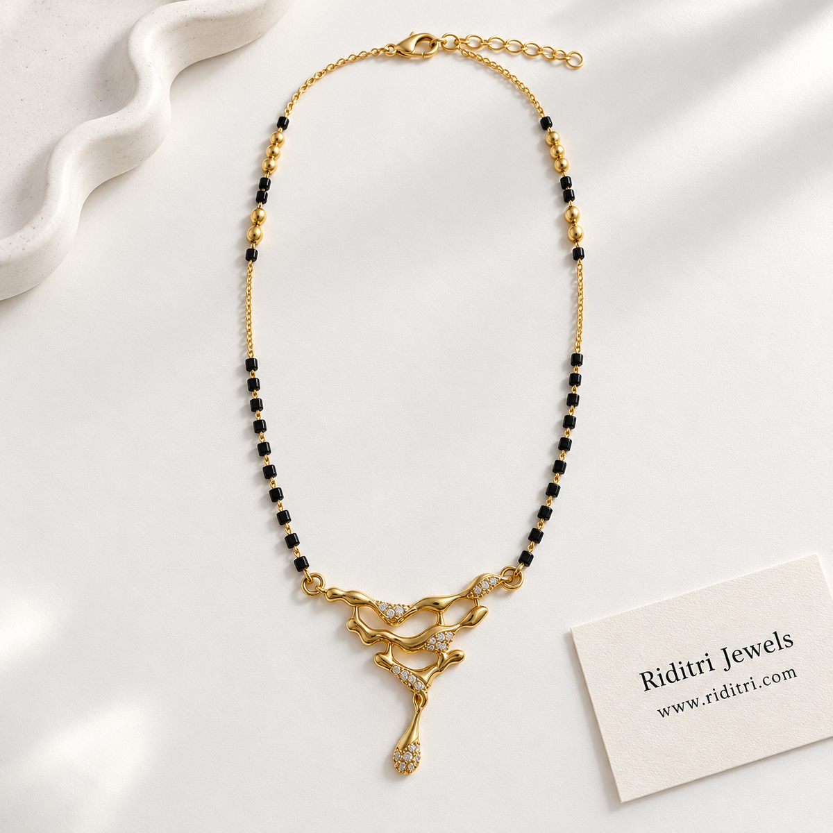 Modern black bead mangalsutra chain with polished gold beads and liquid gold pendant