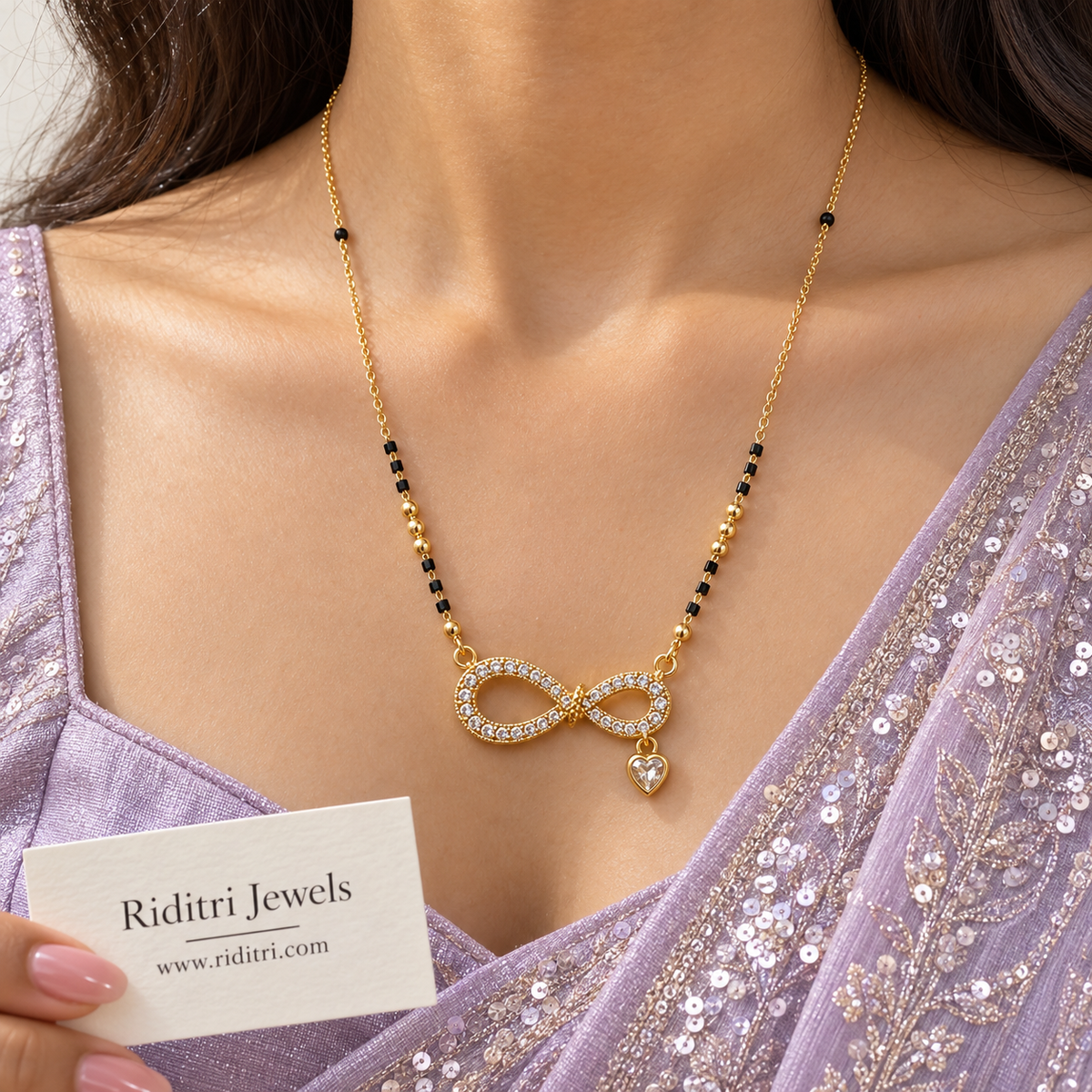 Gold-toned infinity mangalsutra pendant lined with stones and heart-cut stone charm
