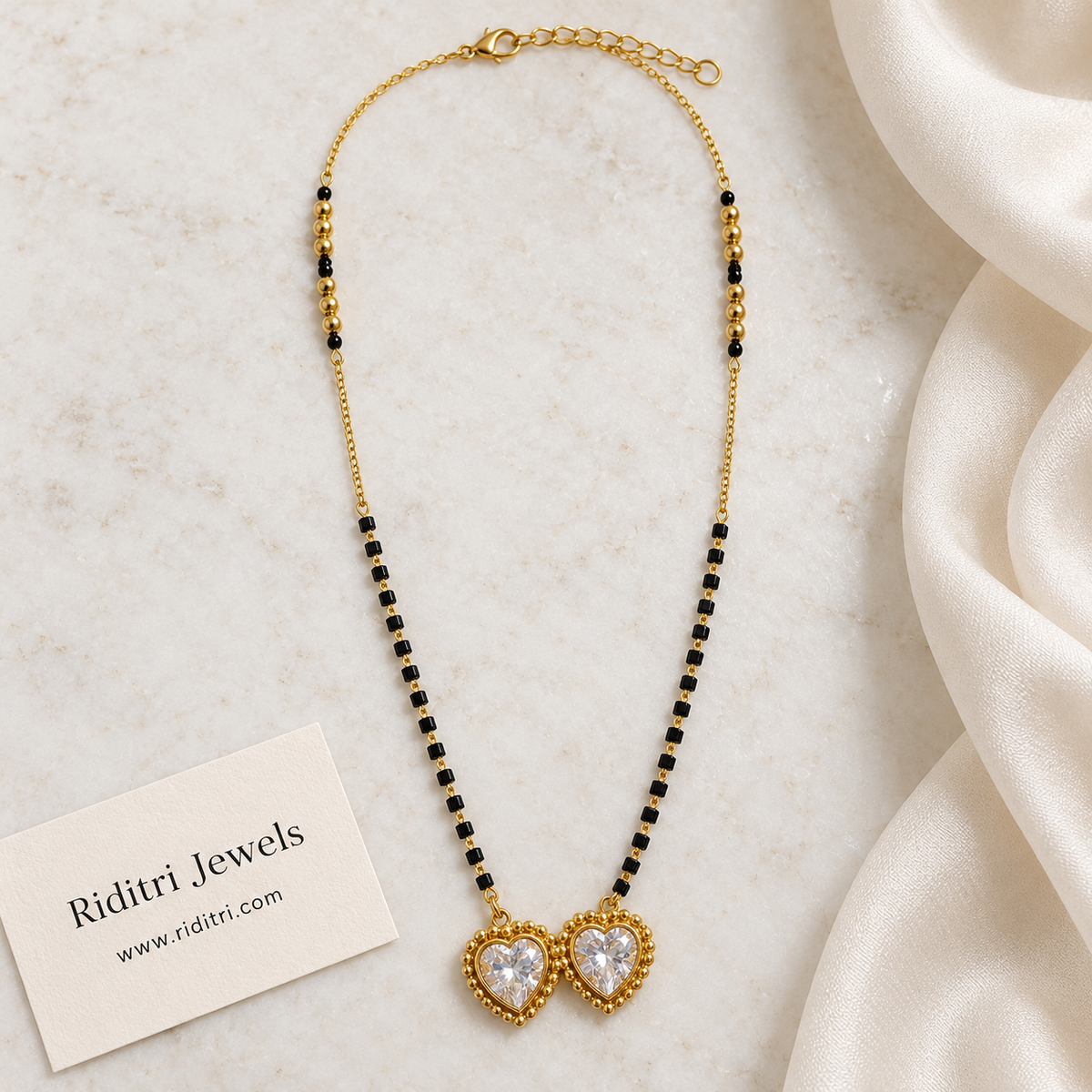 Gold-toned mangalsutra pendant with two big heart stones in beaded gold frames