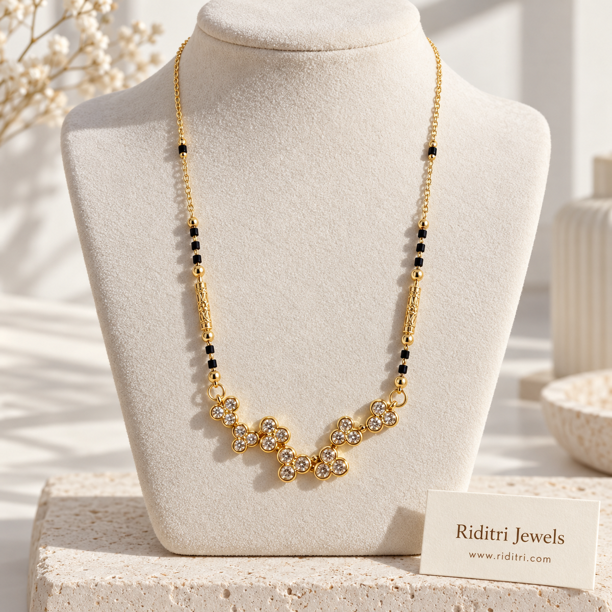 Gold-toned clover flower mangalsutra pendant with round bezel-set stones