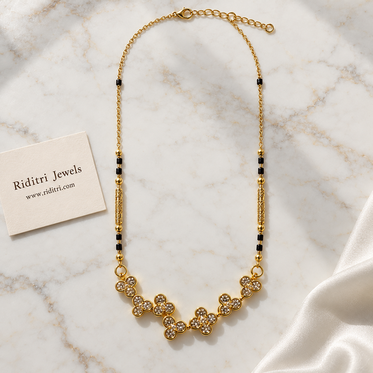 Black bead mangalsutra chain with engraved gold tube beads and clover pendant