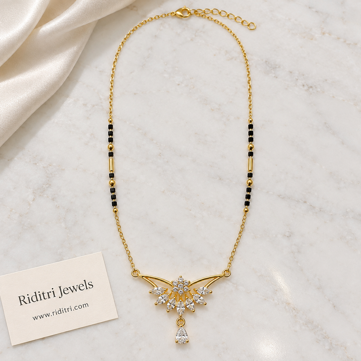 Black bead mangalsutra chain with gold tube beads and winged stone pendant